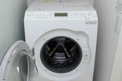a white washing machine with its door open at Shibuya Base in Tokyo