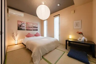 a bedroom with a large white bed and a table at GC TOKYO Shinjuku-Ochiai in Tokyo