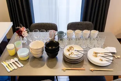 a table with plates and wine glasses on it at GC TOKYO Shinjuku-Ochiai in Tokyo