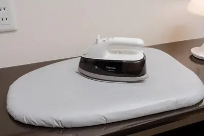 a iron sitting on top of a white cushion at GC TOKYO Shinjuku-Ochiai in Tokyo