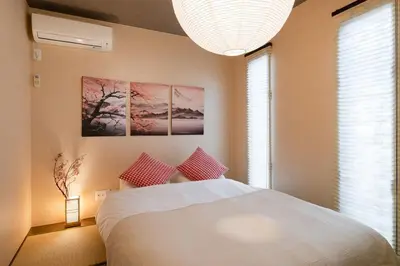 a bedroom with a white bed and a large window at GC TOKYO Shinjuku-Ochiai in Tokyo