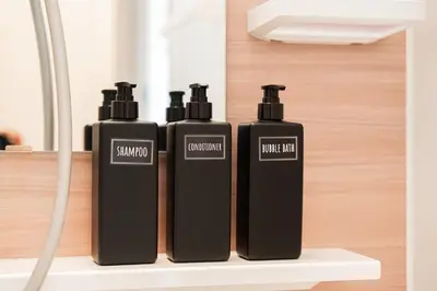 a group of three black bottles sitting on a shelf at Sunlit Canopy - A Cozy Stay in Tokyo Shinjuku Area, with Easy City Access to Shibuya in Tokyo