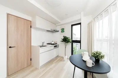 a kitchen with a black table and a sink at Sunlit Canopy - A Cozy Stay in Tokyo Shinjuku Area, with Easy City Access to Shibuya in Tokyo