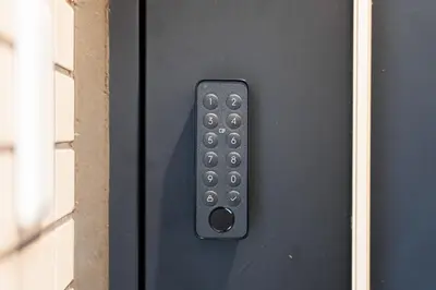 a black door with a remote control on it at Sunlit Canopy - A Cozy Stay in Tokyo Shinjuku Area, with Easy City Access to Shibuya in Tokyo