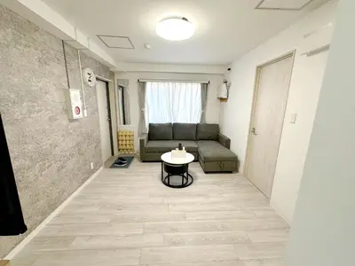 a living room with a couch and a table at \u6696\u71c8 DANTO inn 3F in Tokyo