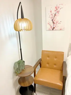 a lamp next to a chair and a table at \u6696\u71c8 DANTO inn 3F in Tokyo