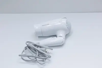 a hairdryer hanging on a wall at Cruise Inn Kitasenju Station Front2 in Tokyo