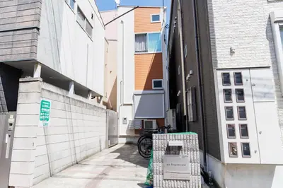 an alley between two buildings with a bike parked on the sidewalk at Cruise Inn Kitasenju Station Front2 in Tokyo