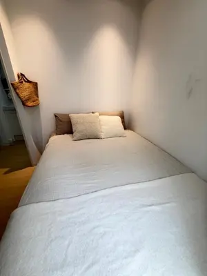 a bed in a corner of a room at PUZZLE hotel 301 in Tokyo