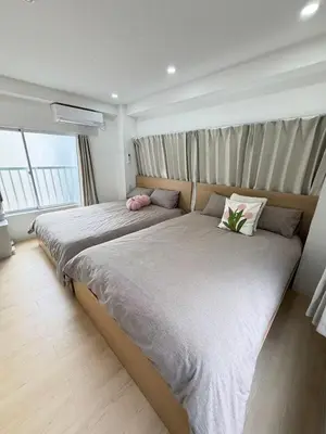 a bedroom with a large bed with two pillows at PUZZLE hotel 301 in Tokyo