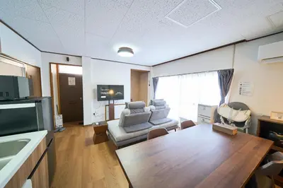 a living room with a couch and a table at Kita-Senju House in Tokyo