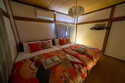 a bedroom with a large bed with towels on it at Kita-Senju House in Tokyo