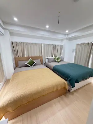 two beds sitting next to each other in a bedroom at PUZZLE hotel 401 in Tokyo