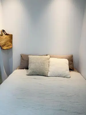 a bed with two pillows on top of it at PUZZLE hotel 401 in Tokyo