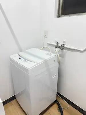 a white washing machine in a bathroom with a mirror at PUZZLE hotel 401 in Tokyo