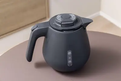 a black tea kettle sitting on a table at FABRIC Nishi-Shinjuku in Tokyo