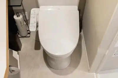 a bathroom with a white toilet in a stall at FABRIC Nishi-Shinjuku in Tokyo