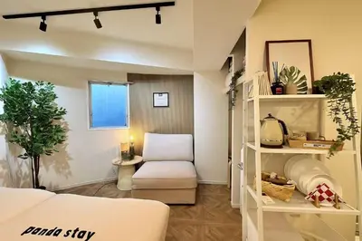 a living room with a couch and a chair at PandaStay\u521d\u53f0\u99c5,\u5f92\u6b657\u5206,\u6e0b\u8c37\u30a8\u30ea\u30a2\u8cb8\u5207\u90e8\u5c4b in Tokyo