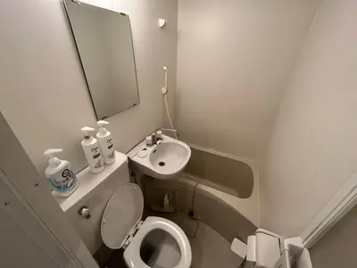 a bathroom with a sink and a toilet and a mirror at 5 min to Shinjuku, 1 min walk to Shinnakano Station, Room 102 in Tokyo