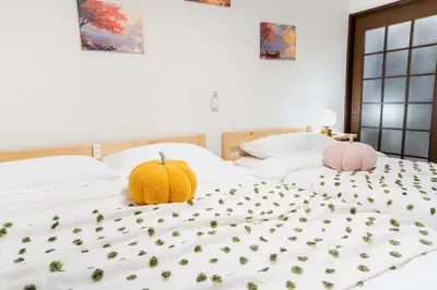 two beds with pumpkins sitting on top of them at 102Room,Free parking just a 7-minute walk from Koiwa tram stop This spacious 75-square-meter flats features two large bedrooms and can accommodate up to seven guests in Tokyo