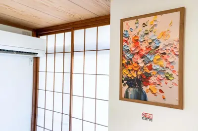 a painting of flowers in a vase on a wall at 102Room,Free parking just a 7-minute walk from Koiwa tram stop This spacious 75-square-meter flats features two large bedrooms and can accommodate up to seven guests in Tokyo