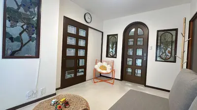 a living room with two doors and a table at 102Room,Free parking just a 7-minute walk from Koiwa tram stop This spacious 75-square-meter flats features two large bedrooms and can accommodate up to seven guests in Tokyo