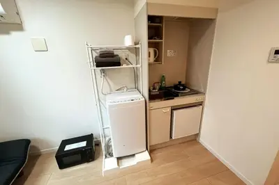 a small kitchen with a refrigerator and a stove at Shinjuku 5 min, Shin-Nakano Station 1 min walk, Room 201 in Tokyo