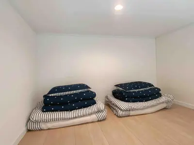 two pillows sitting on the floor in a room at Shinjuku 5 min, 1 min walk from Shinnakano Station, Room 202 in Tokyo