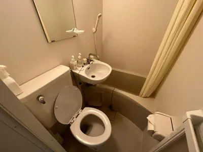 a small bathroom with a toilet and a sink at Shinjuku 5 min, 1 min walk from Shinnakano Station, Room 202 in Tokyo
