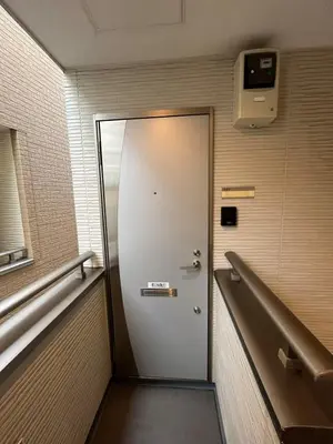 a metal door in a room with a bench at Shinjuku 5 min, 1 min walk from Shinnakano Station, Room 202 in Tokyo