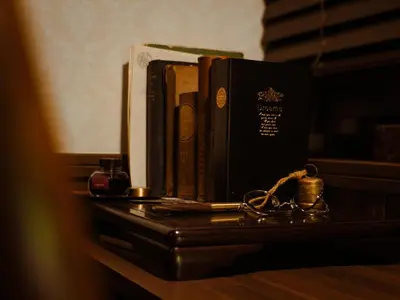 a table with a book and a pair of glasses at Chronos House Tokyo Kitasenju - Time Travel Stay in Tokyo