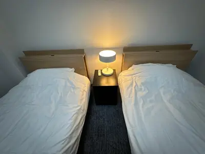 two beds sitting next to each other in a room at PandaStay-Sensoji Asakusa 5minsWalk&SkytreeApt in Tokyo