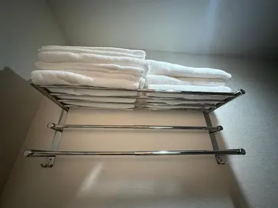 a towel rack with towels on it in a bathroom at PandaStay-Sensoji Asakusa 5minsWalk&SkytreeApt in Tokyo