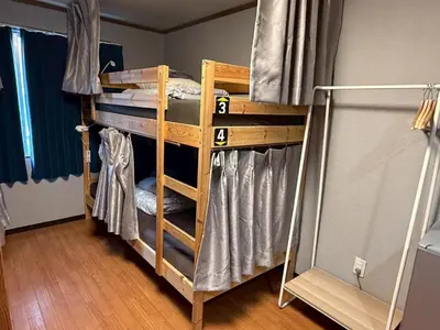 a couple of bunk beds in a room at Male-only dormitory Tokyo House INN in Tokyo