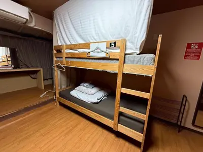 a couple of bunk beds in a room at Male-only dormitory Tokyo House INN in Tokyo