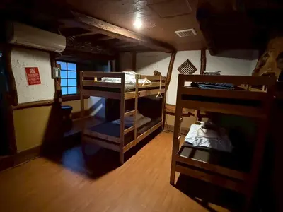 a small room with two bunk beds in it at Male-only dormitory Tokyo House INN in Tokyo