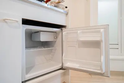 a white refrigerator with its door open in a kitchen at \u6e0b\u8c37\u533a\u3067\u306e\u5bbf\u6cca\u65bd\u8a2d \u99c5\u304b\u30893\u5206 in Tokyo