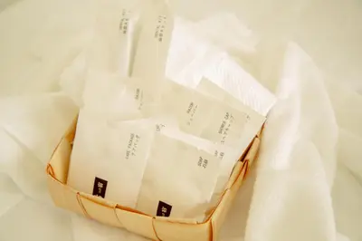 a basket filled with white papers sitting on a white cloth at Ojihoncho301 Triple Room in Tokyo