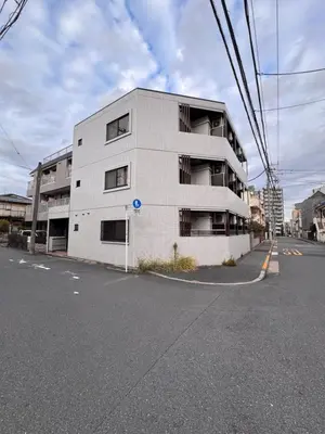 a white building on the side of a street at Ojihoncho301 Triple Room in Tokyo