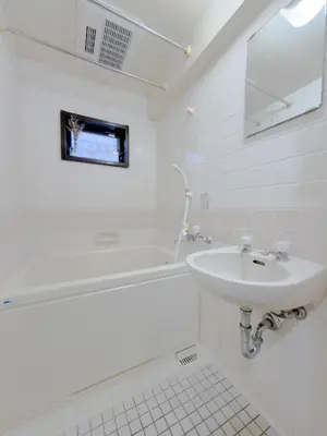 a white bathroom with a sink and a bath tub at Ojihoncho301 Triple Room in Tokyo