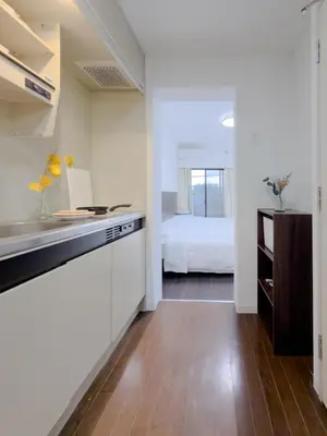 a kitchen with a sink and a bed in a room at Ojihoncho301 Triple Room in Tokyo