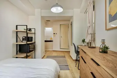 a bedroom with a bed and a desk in it at CraftFlat Komagome 509, a compact studio at excellent location in Tokyo