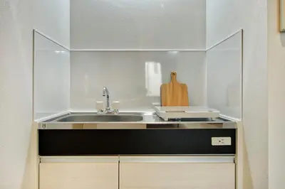 a kitchen with a sink and a counter top at CraftFlat Komagome 509, a compact studio at excellent location in Tokyo