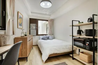 a bedroom with a bed and a desk and a television at CraftFlat Komagome 509, a compact studio at excellent location in Tokyo