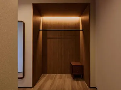 a hallway with a closet with a wooden door at illi Aest Shinagawa-Gotanda in Tokyo