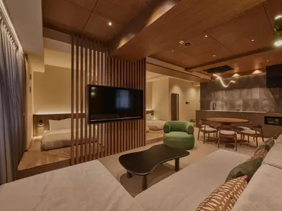 a living room with a television and a dining room at illi Aest Shinagawa-Gotanda in Tokyo
