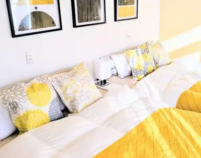 a couch with pillows on it in a living room at Shinjuku Nakai House in Tokyo