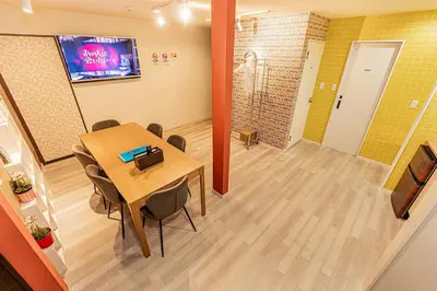 a room with a table and chairs and a television at Tokyo Skytree House 3LDK, 2Bath, 8 Guests, 6min to Keisei Hikifune in Tokyo