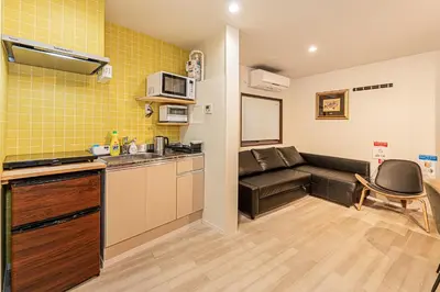 a small kitchen with a couch in a room at Tokyo Skytree House 3LDK, 2Bath, 8 Guests, 6min to Keisei Hikifune in Tokyo