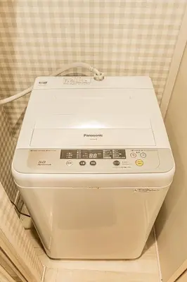 a white washing machine sitting on top of a counter at Tokyo Skytree House 3LDK, 2Bath, 8 Guests, 6min to Keisei Hikifune in Tokyo